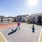 Outdoor pickleball court with a smooth playing surface, modern net, and surrounding fence for recreational play.
