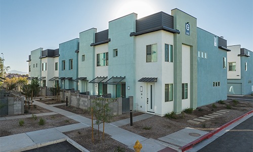 apartment building with trees and a walkway